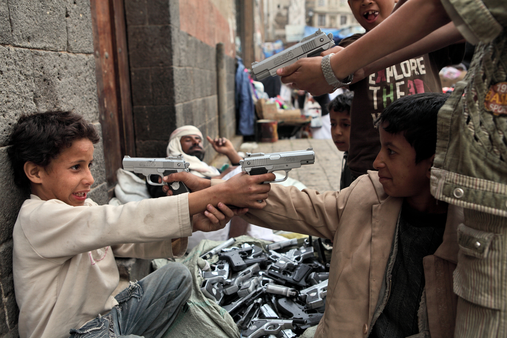 Children playing with toy guns on a street in Sanaa (Vladimir Melnik via Shutterstock)